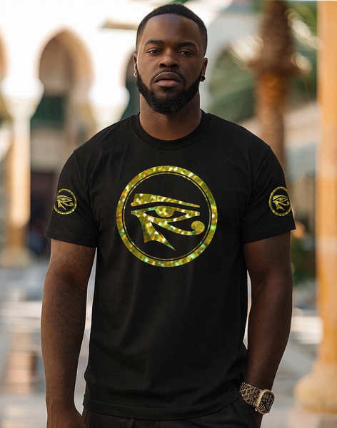 Man wearing a black t-shirt with a gold EYE OF HORUS symbol, standing outdoors.
