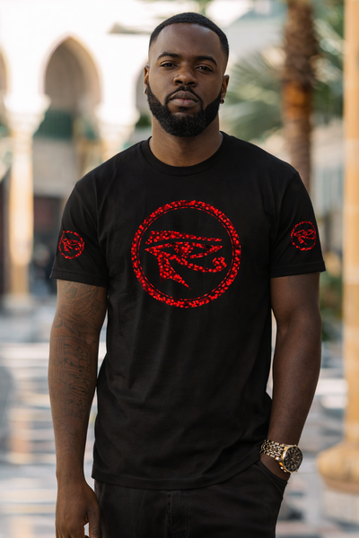 Man wearing a black t-shirt with red graphics in an outdoor setting