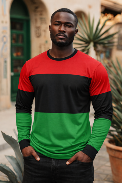 Man wearing a red, black, and green long-sleeve shirt standing outdoors.