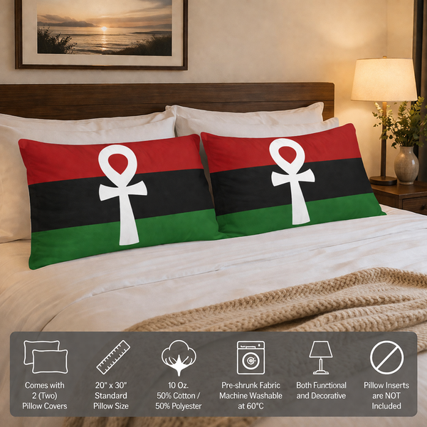 Two pillow covers with a white ankh symbol on a bed in a bedroom setting.