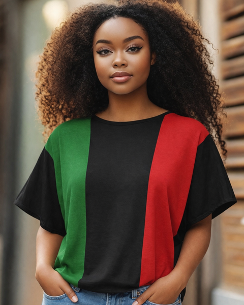 Woman wearing a black t-shirt with green and red panels, standing outdoors.