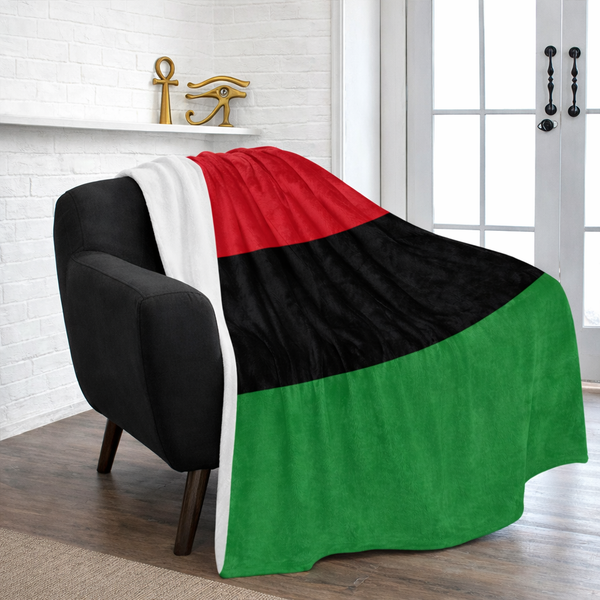 Flag with red, black, and green colors draped over a chair in a room.