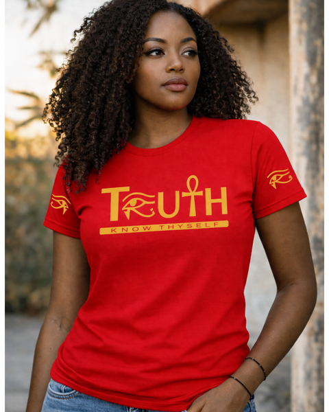 Woman wearing a red t-shirt with 'TRUTH' printed on it, standing outdoors.