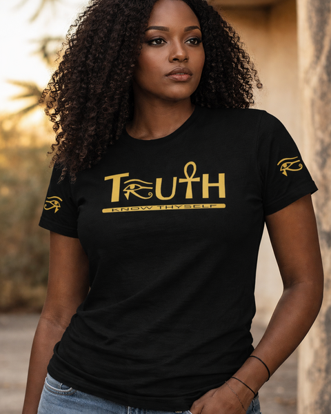 Woman wearing a black t-shirt with 'TRUTH' printed in gold, standing outdoors. Nubianlxuriesbrand Afrikemetic Kollection